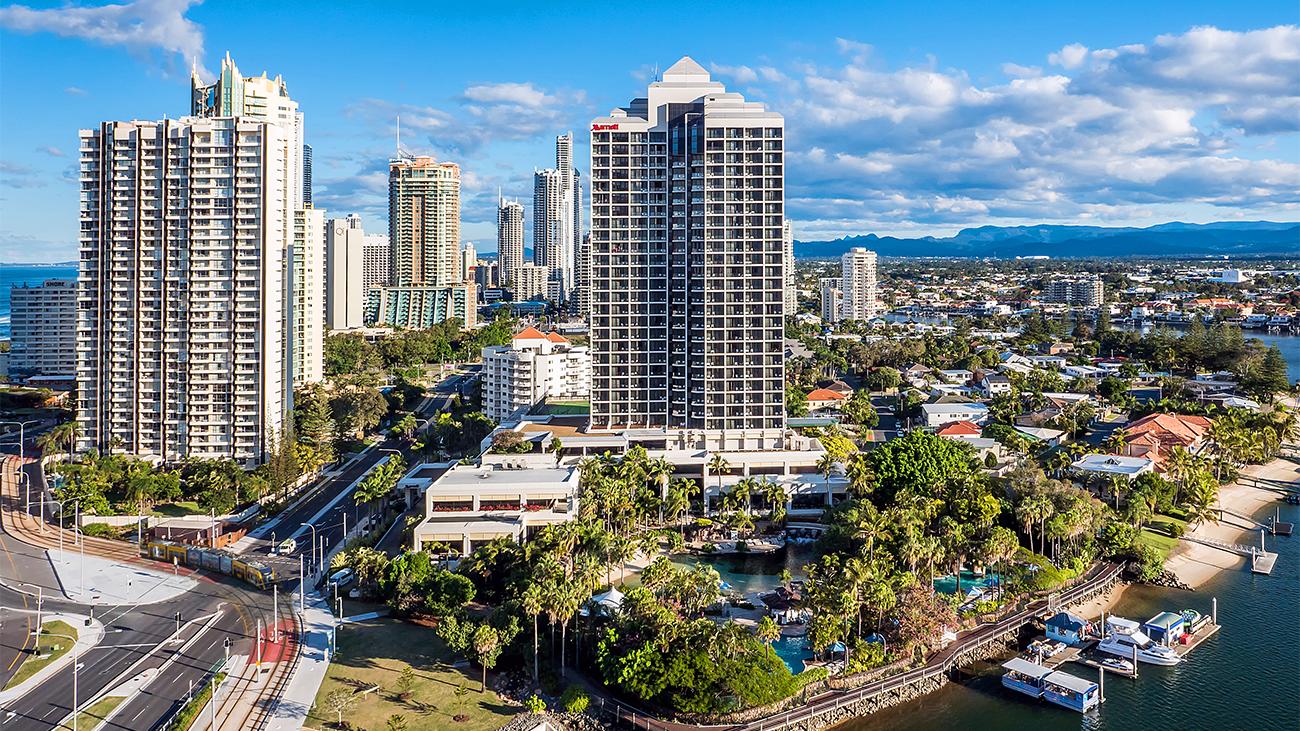 Aerial of exterior of Marriott Vacation Club at Surfers Paradise resort timeshare with waterway and boat docks in foreground